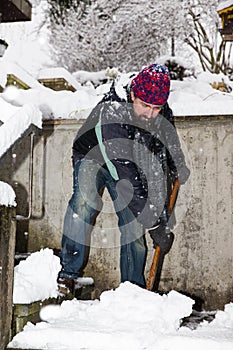 Man is snow shoveling the stairs