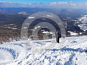 Man with snowboard in Sheregesh