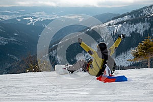Man snowboarder with slovakia flag at ski resort slope