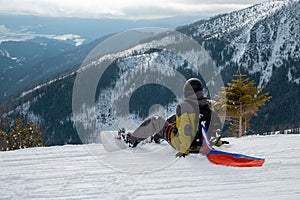 Man snowboarder with slovakia flag at ski resort slope