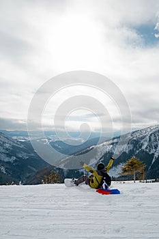 Man snowboarder with slovakia flag at ski resort slope