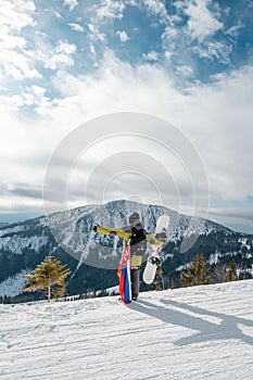 Man snowboarder with slovakia flag at ski resort slope