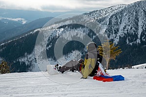 Man snowboarder with slovakia flag at ski resort slope