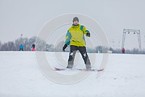 man snowboarding down by hill