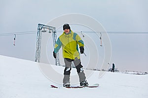 man snowboarding down by hill