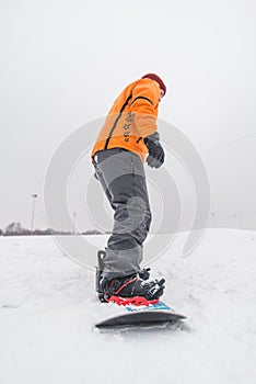 man snowboarding down by hill