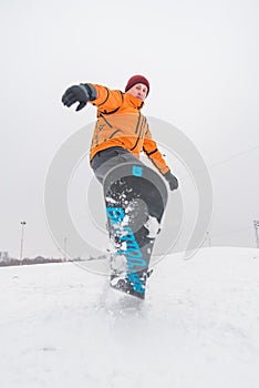 man snowboarding down by hill