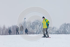 man snowboarding down by hill