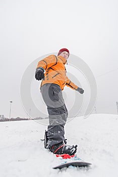 man snowboarding down by hill