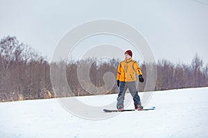 man snowboarding down by hill