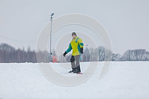 man snowboarding down by hill