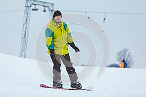 man snowboarding down by hill