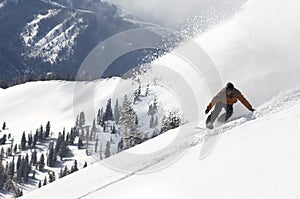 Man Snowboarding Down Hill