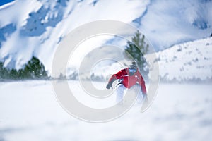 Man snowboarding down hill
