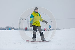 man snowboarding down by hill
