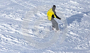 A man snowboarding a mountain in the snow in winter