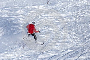 A man snowboarding a mountain in the snow in winter