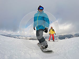 Man snowboarding at ski resort. Winter