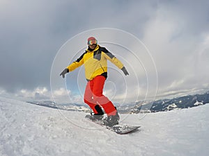 Man snowboarding at ski resort. Winter vacation