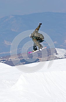 Man snowboarding on slopes of Pradollano ski resort in Spain