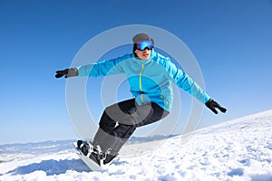 Man snowboarding on snowy hill. Winter vacation