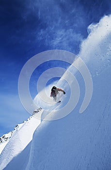 Man Snowboarding On Steep Slope photo
