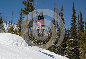 Man snowboarding trick jump on mountain snow jump