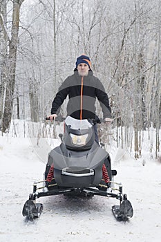 A man on a snowmobile. Equipment for driving through snow in winter