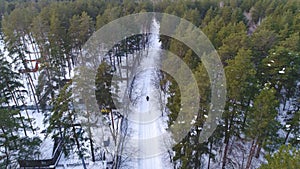 A man on a snowmobile in the woods. Winter sports and entertainment.