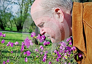 Man snuffing a flower.
