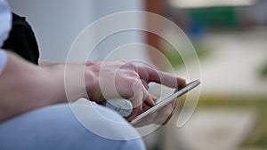 Man soars electronic cigarette while sitting with the phone close-up