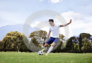 Man, soccer player and shooting with ball on field with power, speed and aim at target in training for club. Person
