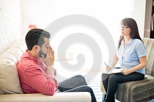 Man with social anxiety at psychotherapist for treatment