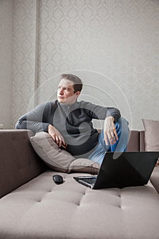 The man on a sofa with laptop