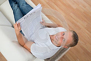 Man On Sofa With Newspaper