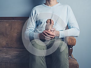 Man on sofa with strange potato