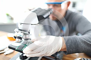 Man soldering using microscope