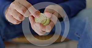 man with some bitcoins in his hands in closeup