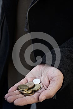 Man with some czech koruna coins in his hand