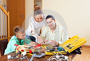 Man with son doing something with working tools
