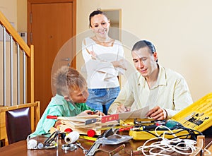 Man with son doing something with the working tools