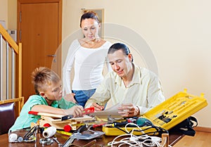 Man with son doing something with working tools