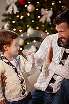 Man with son giving five in Christmas eve