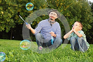 Man and son looking at soap bubble