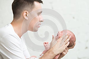 Man soothing a screaming newborn