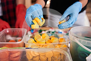 Man sorting and putting colorful plastic cap