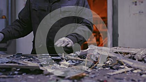 Man sorts metal rubbish. Male sorts garbage, electronics or plastic. Conveyor belt, trash, the line