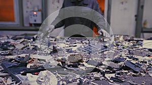 Man sorts metal rubbish. Male sorts garbage, electronics or plastic. Conveyor belt, trash, the line