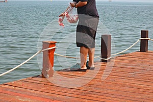 a man sows flowers into the sea