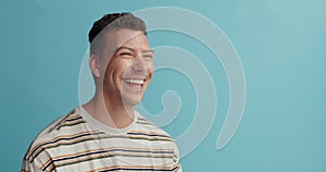 Man, space and laughing in fashion with studio, happy and excited with trendy style by blue background. Person, model or